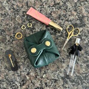The Ellie Mini green leather pouch travel case gold hardware snap button closure